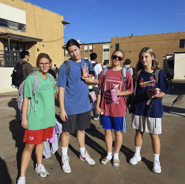 From left to right, PHS seniors Kate Rich, Amelia Robbins, Annie Parsons, and Zoe Brown pose for a picture of their coolest Adam Sandler-inspired dad outfits. 